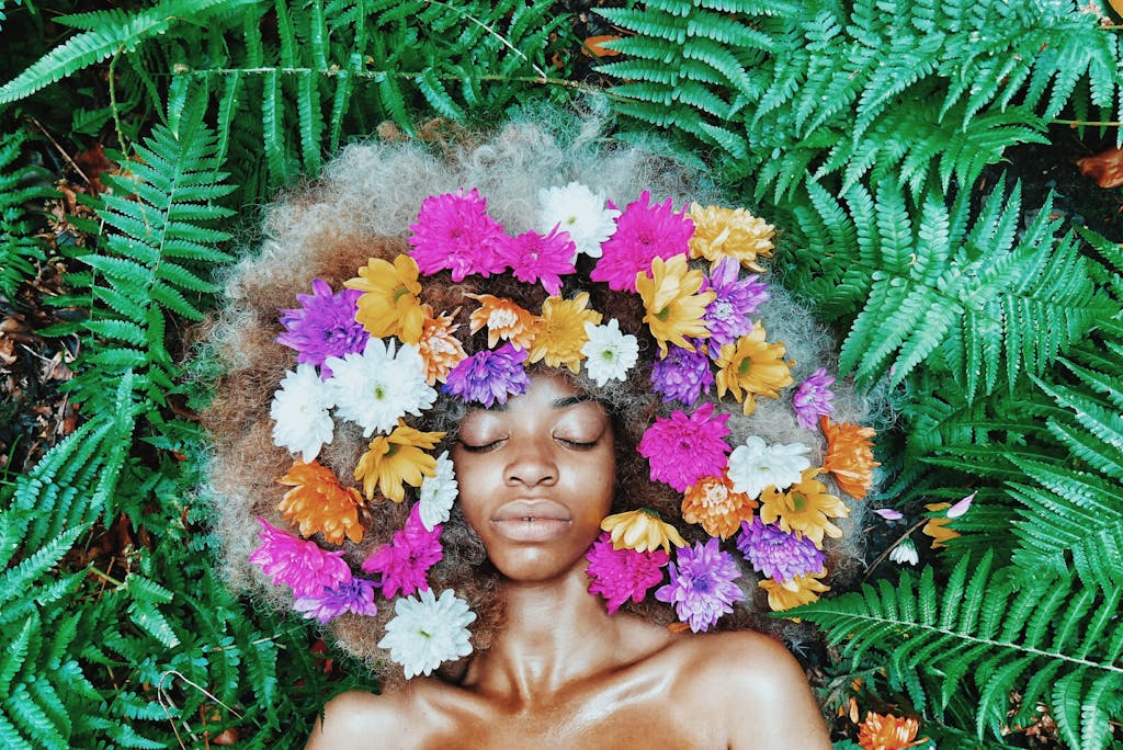 Sovereign Woman Spiritual Rebirth - Serene portrait of a woman with flowers in her afro.